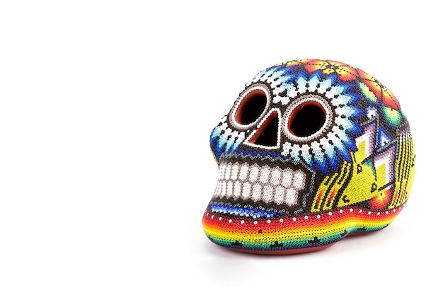 Colorful skulls, Mexican handicrafts. Day of the Dead, handmade Huichol figure of chaquira, Mexico