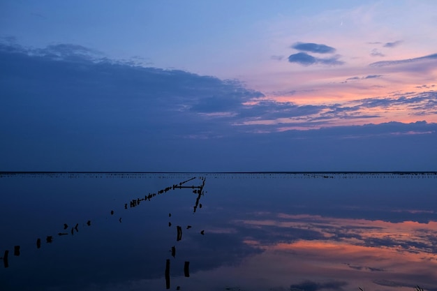 Colorful sky and colorful water in salt lake reflected in the sunset