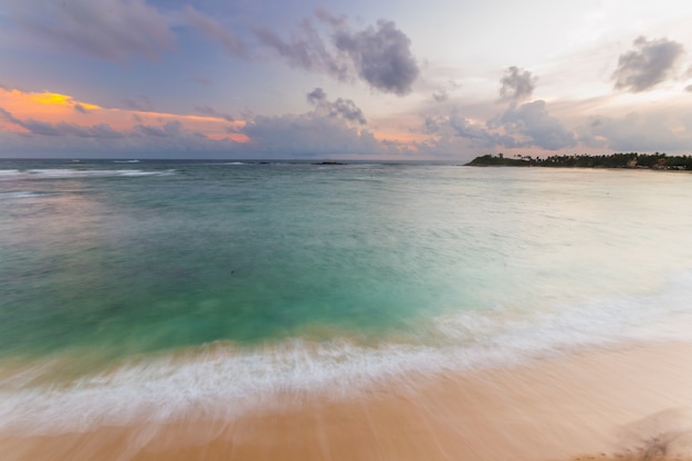 Colorful sky at sunset on desert tropical beach