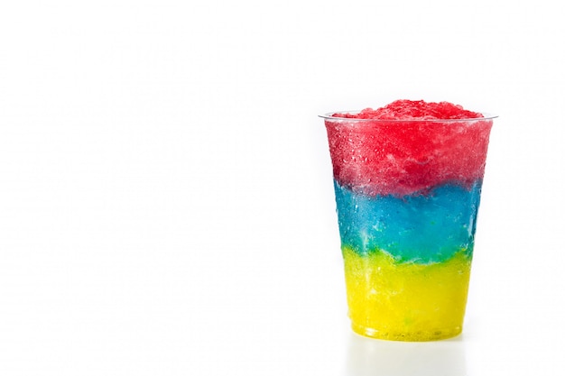 Colorful slushie of differents flavors with straw in plastic cup