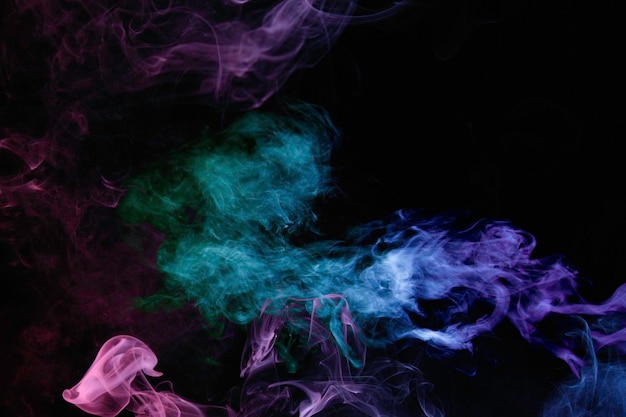 Colorful smoke and fog on dark background.