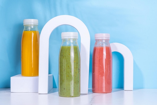 Colorful smoothies in glass bottles