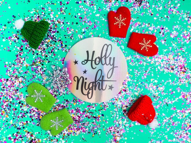 Colorful Sparkling Glitter confetti Christmas Holidays abstract background ispired by neo mint color of 2020 holly night text in holographic paper