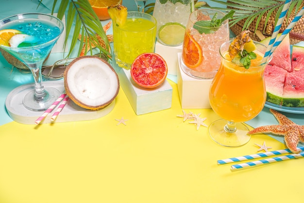 Colorful summer drinks set. Various bright alcohol cocktails and beverages, in different glasses, with tropical fruit