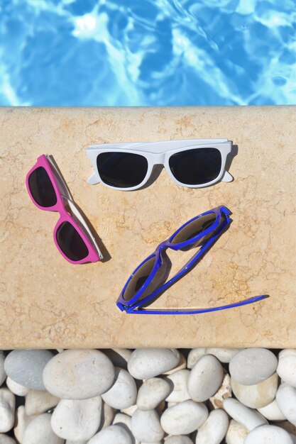 Colorful sunglasses by the poolside