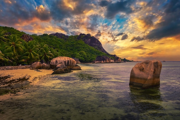 Colorful sunset over anse source dargent beach at la digue island seychelles