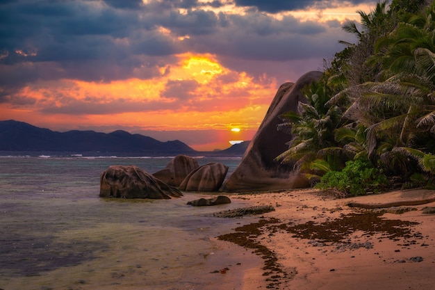 Colorful sunset over anse source dargent beach at la digue island seychelles