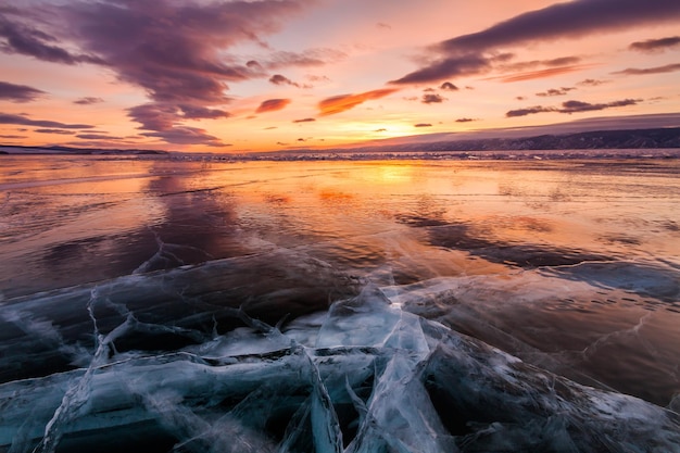 Colorful sunset over the crystal ice of Baikal lake