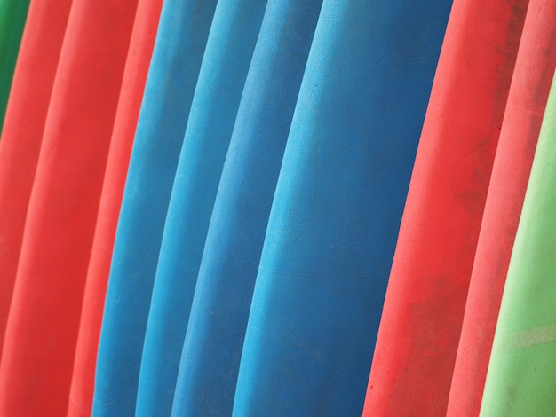 Colorful surfboards stand in a row for hire