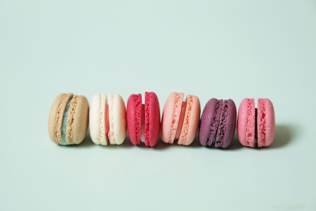 Colorful of sweet French macaroons on pastel color background,copy space.