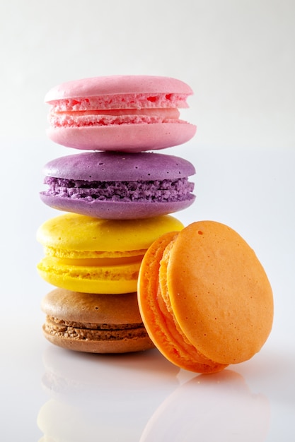 Colorful and tasty French Macarons on white background