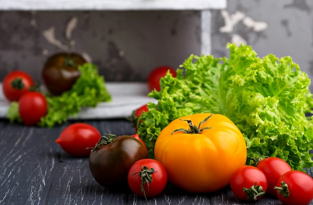 Colorful tomatoes on black background