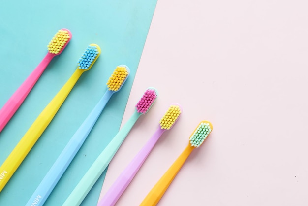 colorful toothbrushes on a color background top view