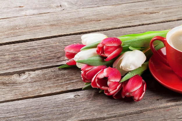 Colorful tulips bouquet and coffee cup