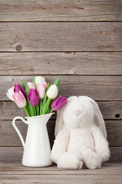 Colorful tulips bouquet and rabbit toy