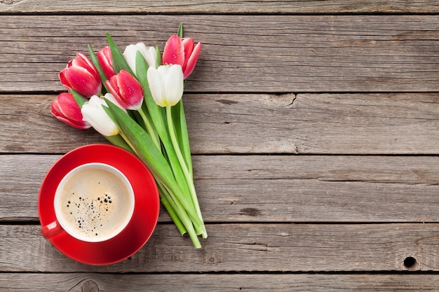 Colorful tulips and red coffee cup