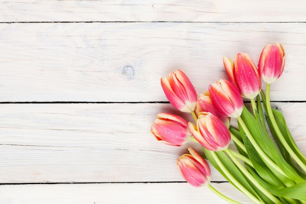 Colorful tulips on wooden table