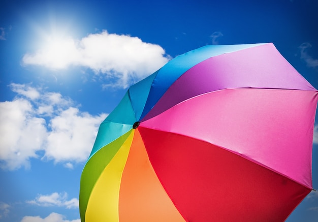 Colorful umbrella against the sky with the sun 