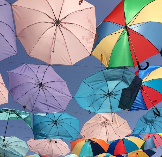 Colorful umbrellas against sky