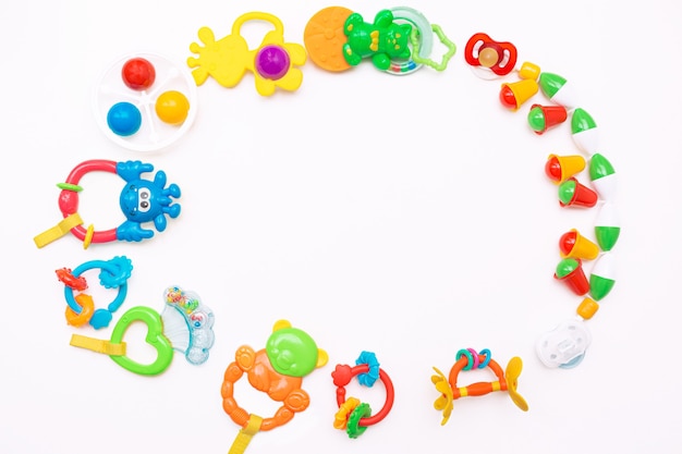 Colorful and various plastic toys for babies are arranged in a circle