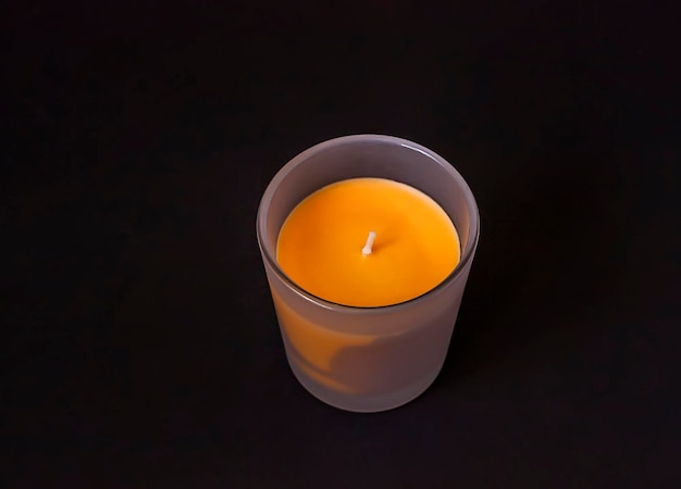 Colorful wax candle in a glass