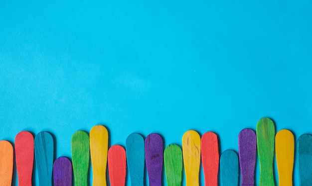 colorful wood ice-cream stick on blue background