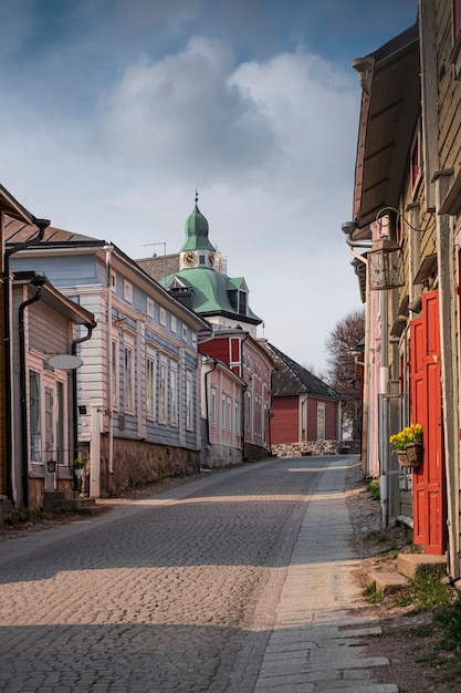 Colorful wooden houses in a narrow street in the historic center of the town overlooking Porvoo Cathedral in Finland on a sunny spring day