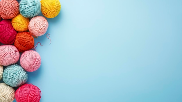 Photo colorful yarn balls for knitting on blue background with copy space