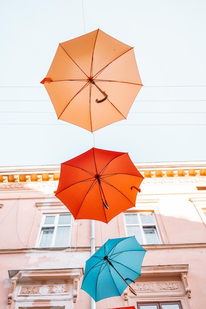 Colorfull umbrellas as festival decoration in urban city centre Lviv. Yellow, red, blue and red color umbrellas on sky background.