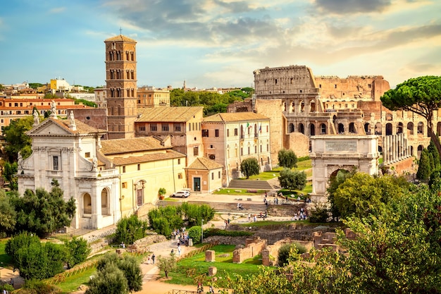 The Colosseum and Arch of Constantine in Rome, Italy during summer sunny day sunset. The world famous colosseum landmark in Rome.