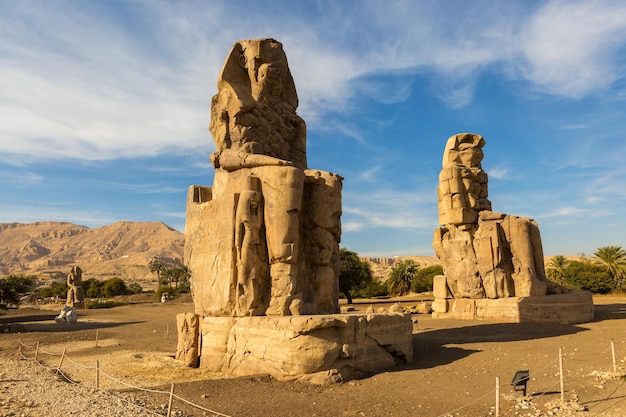 Colossi of Memnon Luxor Thebes against the background of dawn in the Egypt