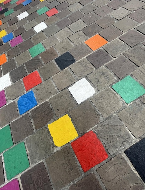 Coloured tiles on a pavement in a downfacing perspective