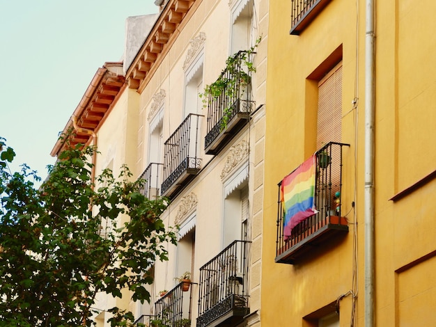 Colourful buildings with rainbow flag of gay community on balcony Symbol of support for LGBTQ people