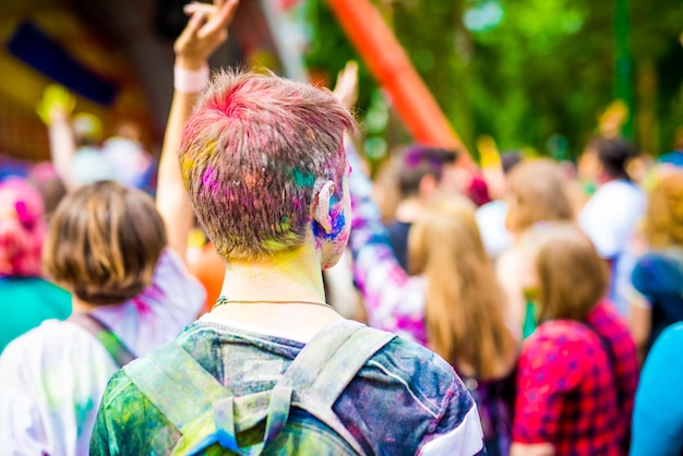 Colourful man on holi festival backview