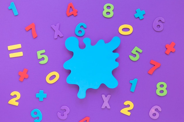 Colourful math numbers arrangement with blue copy space stain