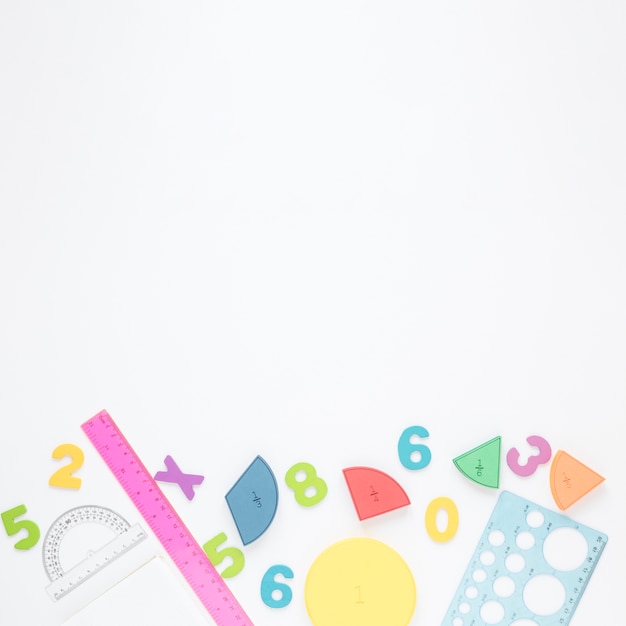 Colourful numbers and stationery on white copy space background