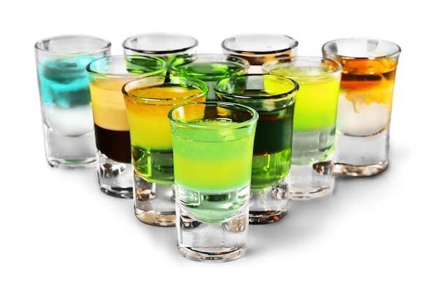 Photo colourful shot drinks on a white background with reflections