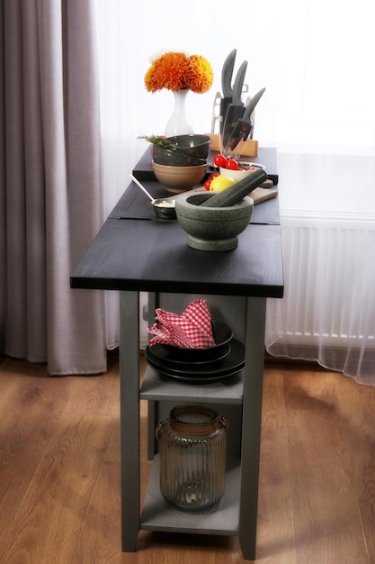 Colourful tableware with products on kitchen table