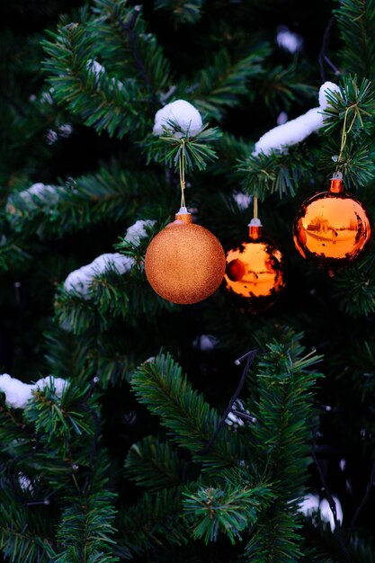 Colourful toy balls hang on a christmas tree outdoor horizontal photo