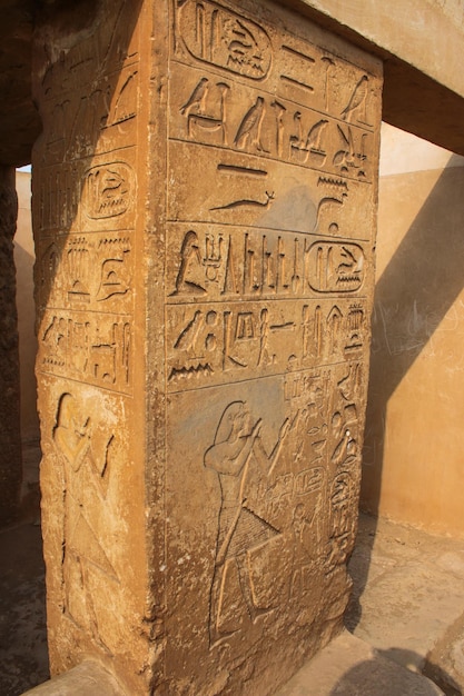 The column with hieroglyphs near the pyramid of Djoser. Egypt.