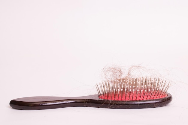 Comb and hair on white background alopecia