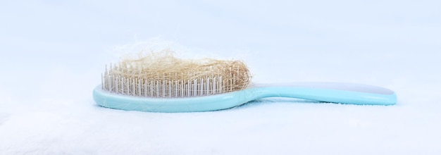 Comb with hair on a white background Selective focus