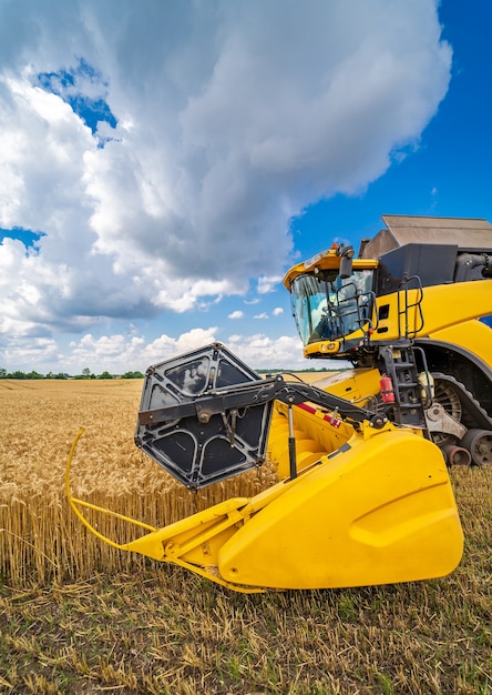 Combine harvester at work on a field of wheat. Agricultural machinery theme. Part of heavy technic.