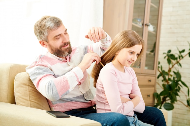 Combing Hair of Little Daughter