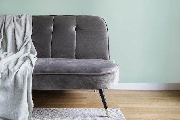 Comfortable grey couch with plaid in living room