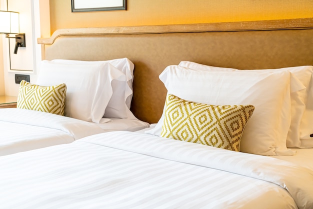 comfortable pillows decoration on bed in hotel bedroom