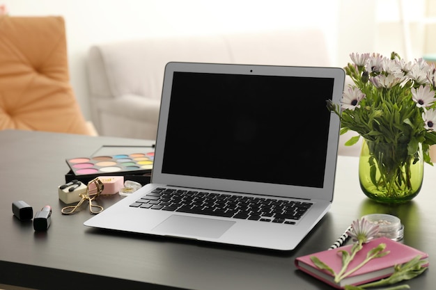 Comfortable workplace of beauty blogger with modern laptop on table