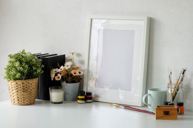 Comfortable workspace with mockup poster frame and copy space.