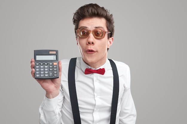 Comic accountant with calculator in studio