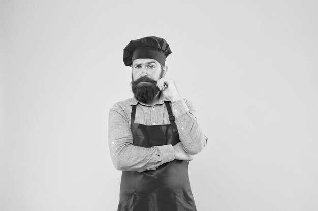 Committed to good food mature hipster with serious face satisfied bearded chef brutal butcher in apron best menu offer confident bearded happy chef white uniform Male chef in red uniform